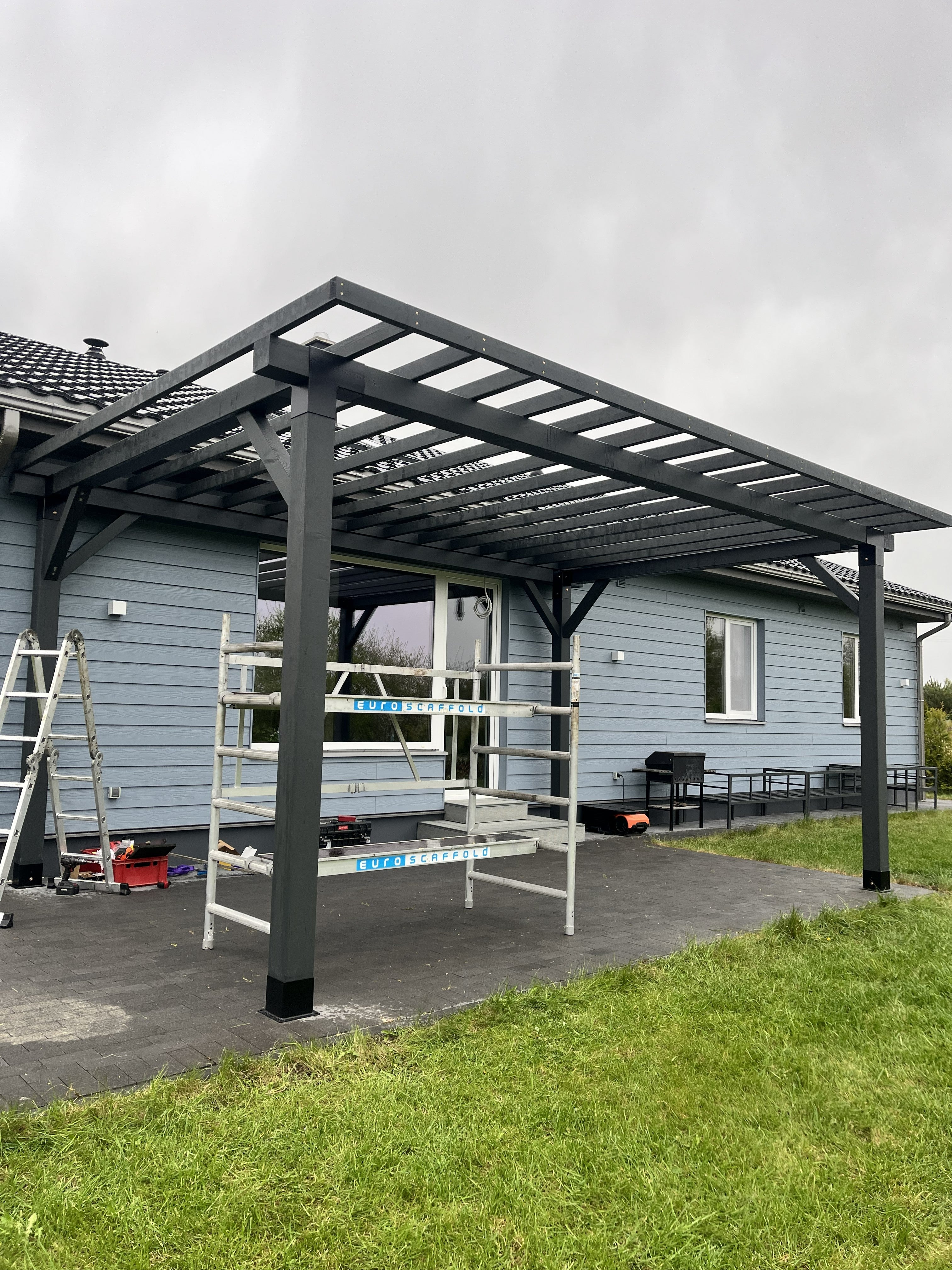 Modular DIY canopy by Terases, 6m x 4m, showing the assembled frame and fabric cover in a backyard setting.