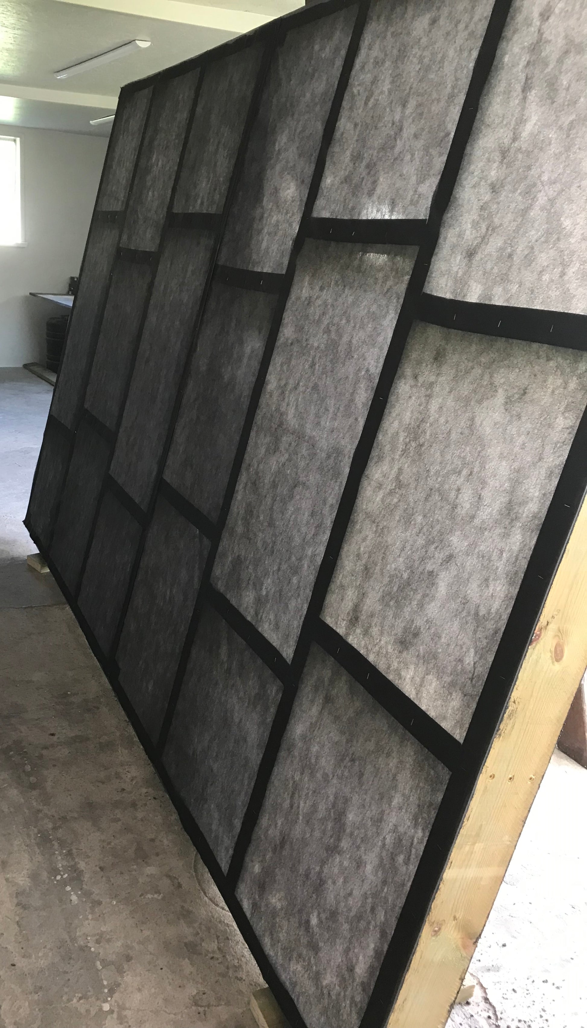 Wall with geometric black and gray pattern in an indoor setting