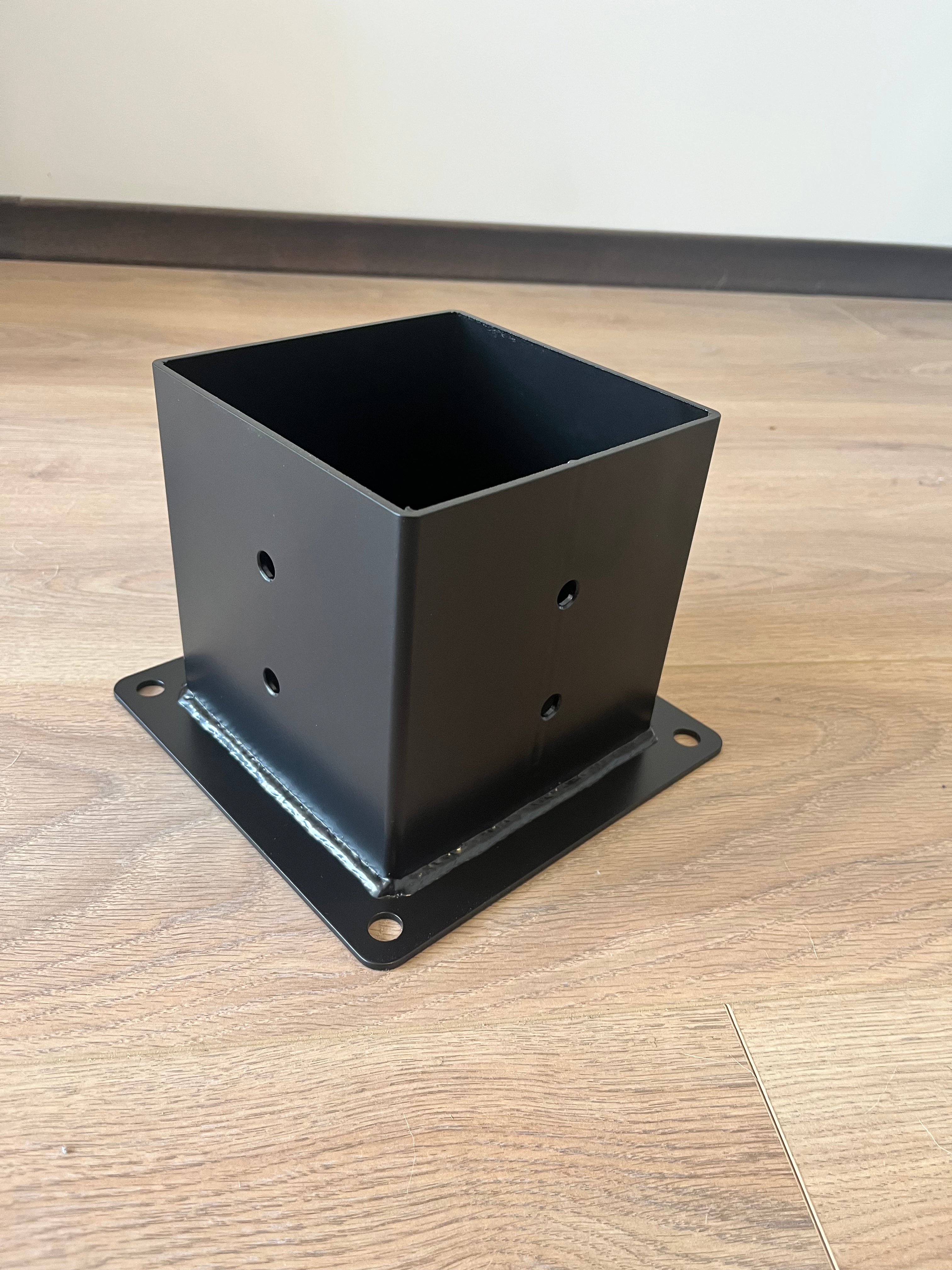 Terases Post Base Bracket for 145x145mm lumber, metal support with mounting holes for secure outdoor posts.