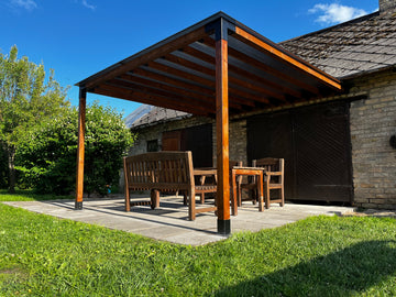 Wooden pergola with outdoor furniture on a patio area.