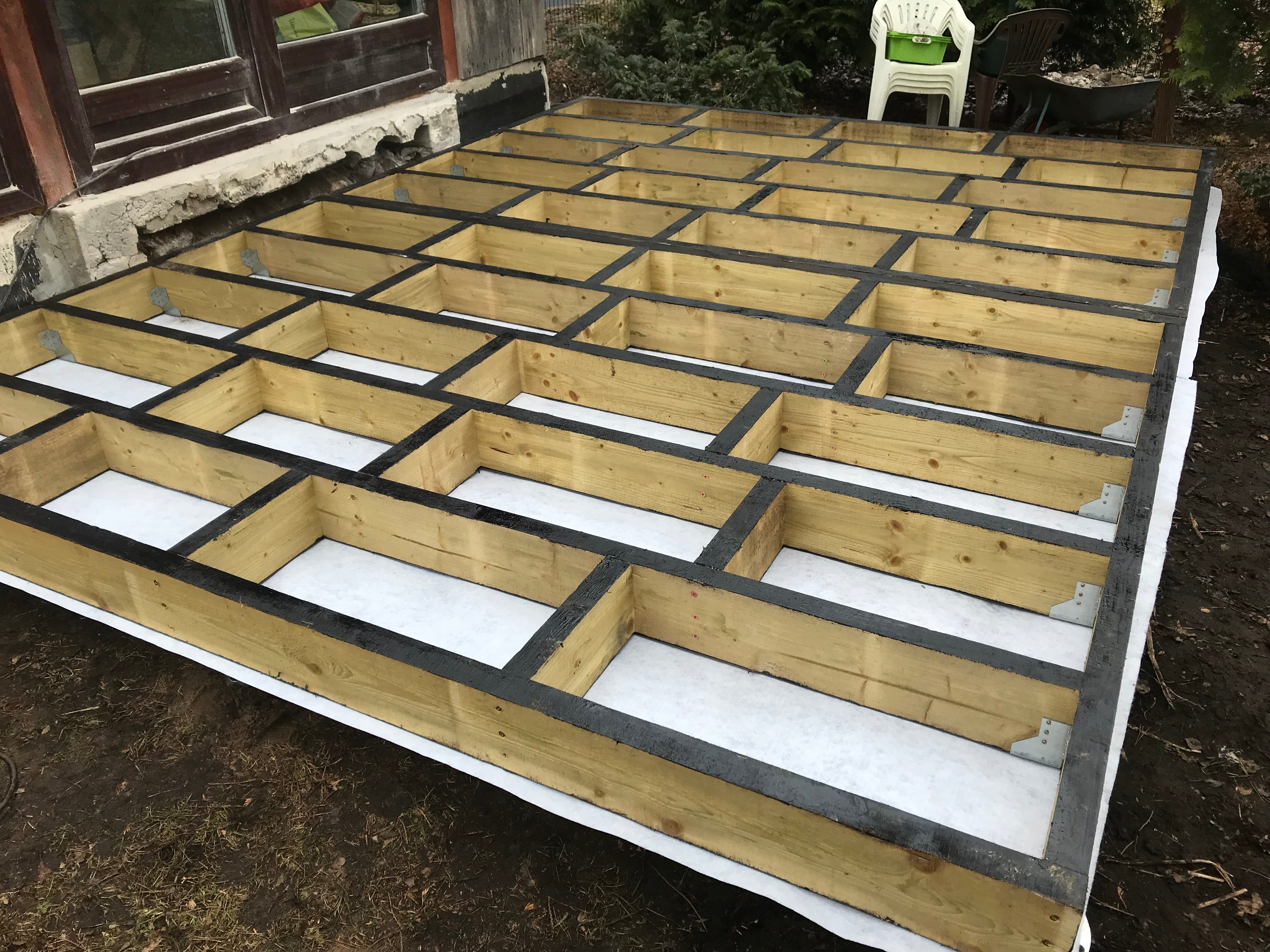 Wooden floor foundation with insulation in a backyard setting