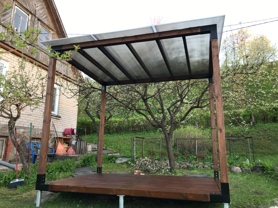 Wooden pergola structure in a garden setting with trees and a car in the background.