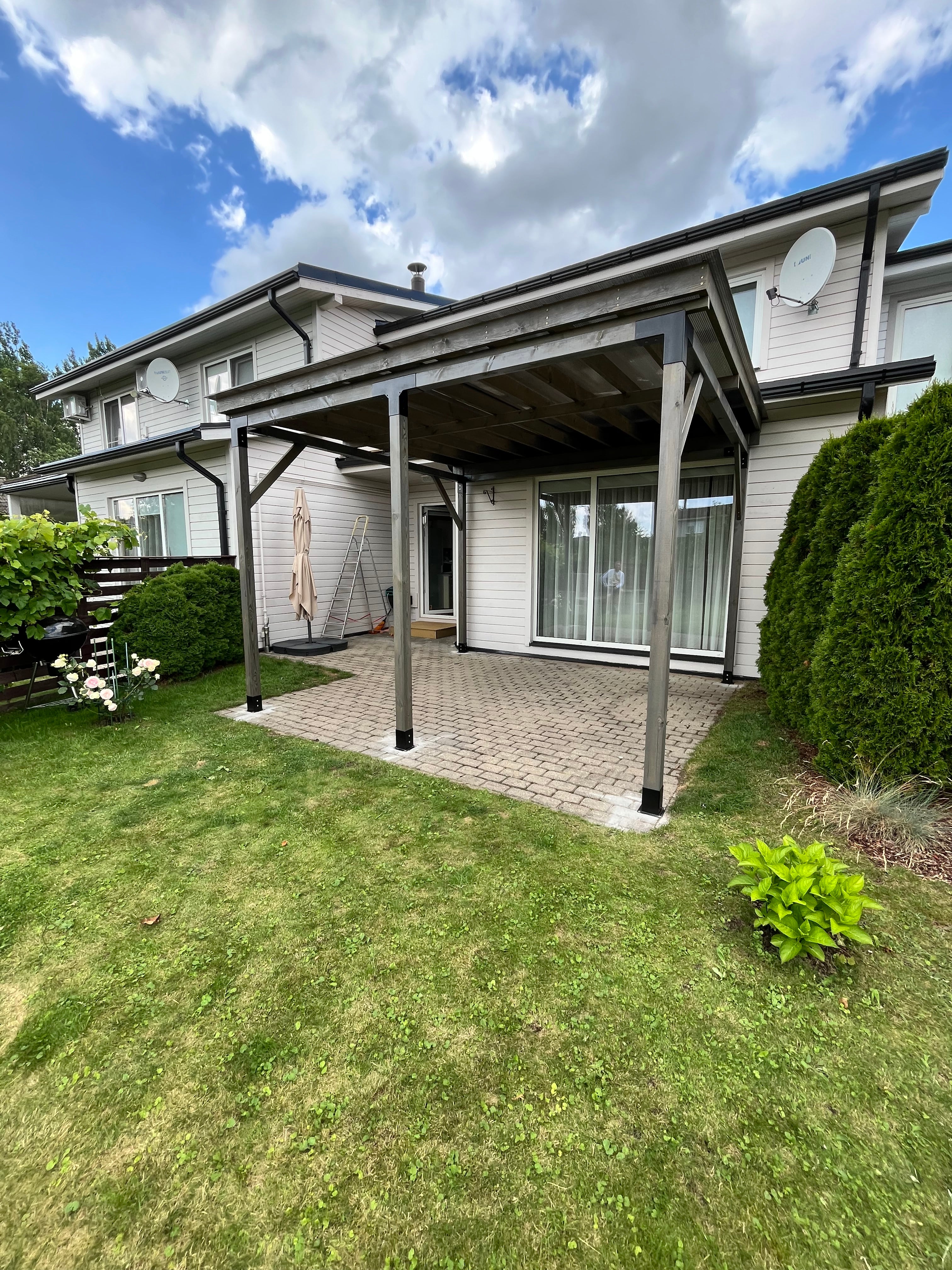 House exterior with a covered porch and grassy area