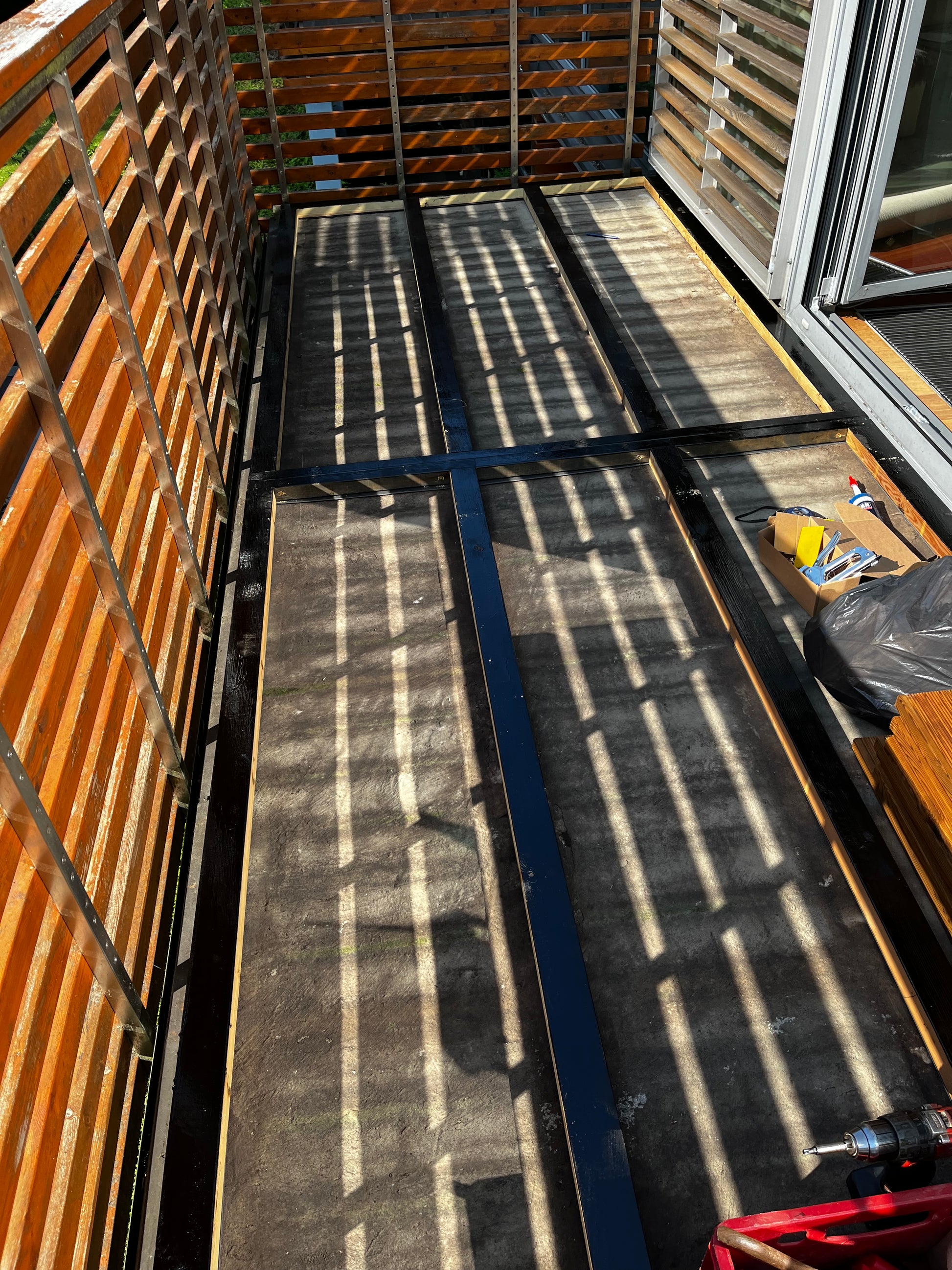 Person working on a large metal surface with tools, possibly in an industrial setting.