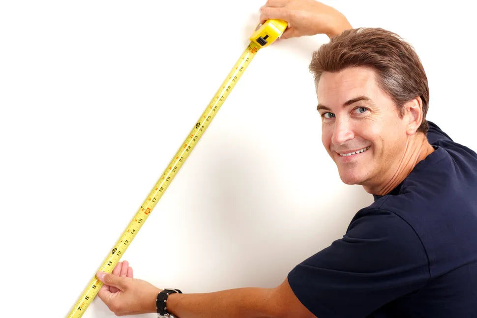 Man holding a measuring tape and measuring his dream terrace deck