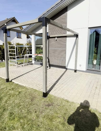 Patio cover attached to a house with a clear sky background