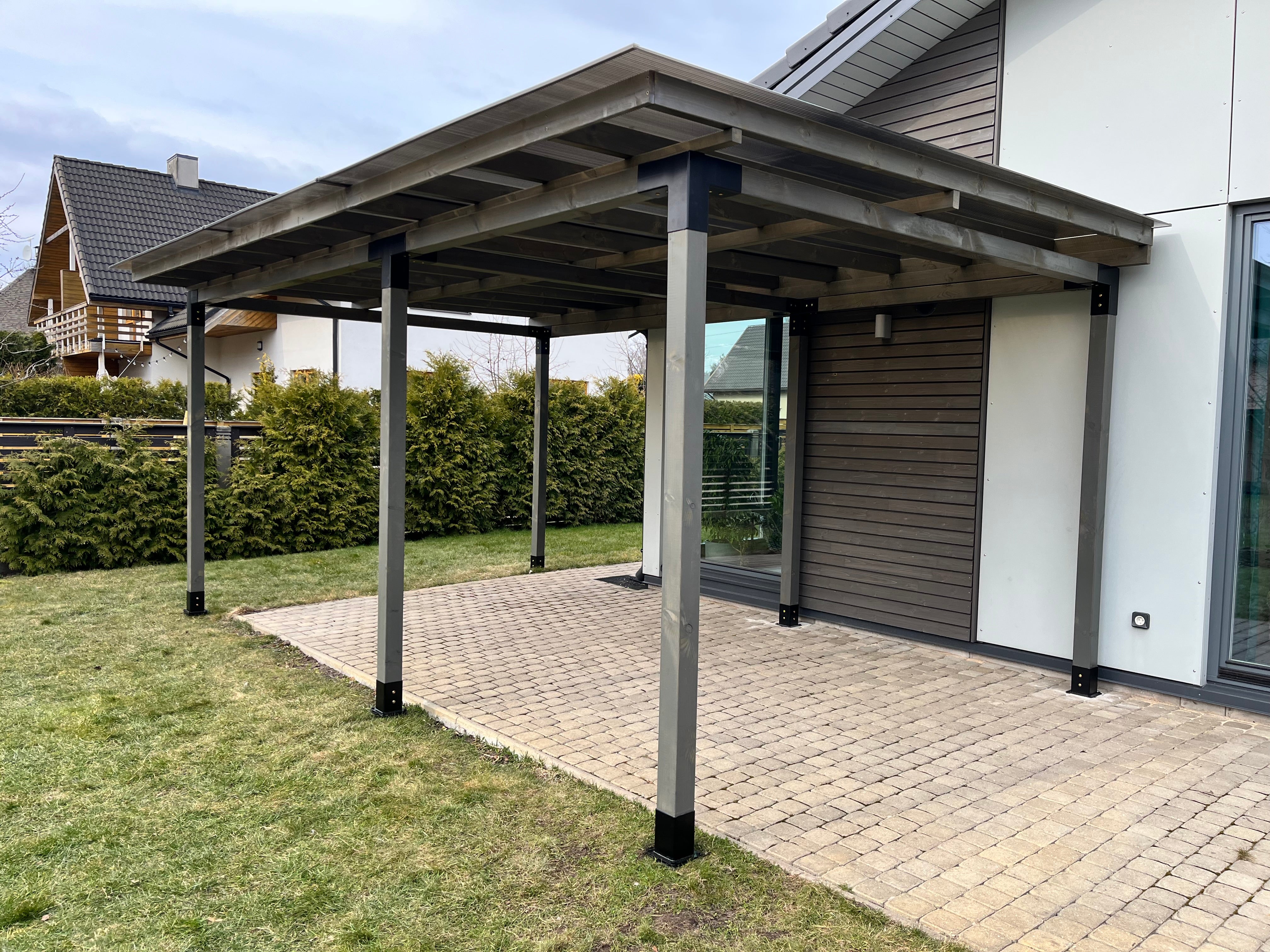 Carport attached to a house with a clear sky background