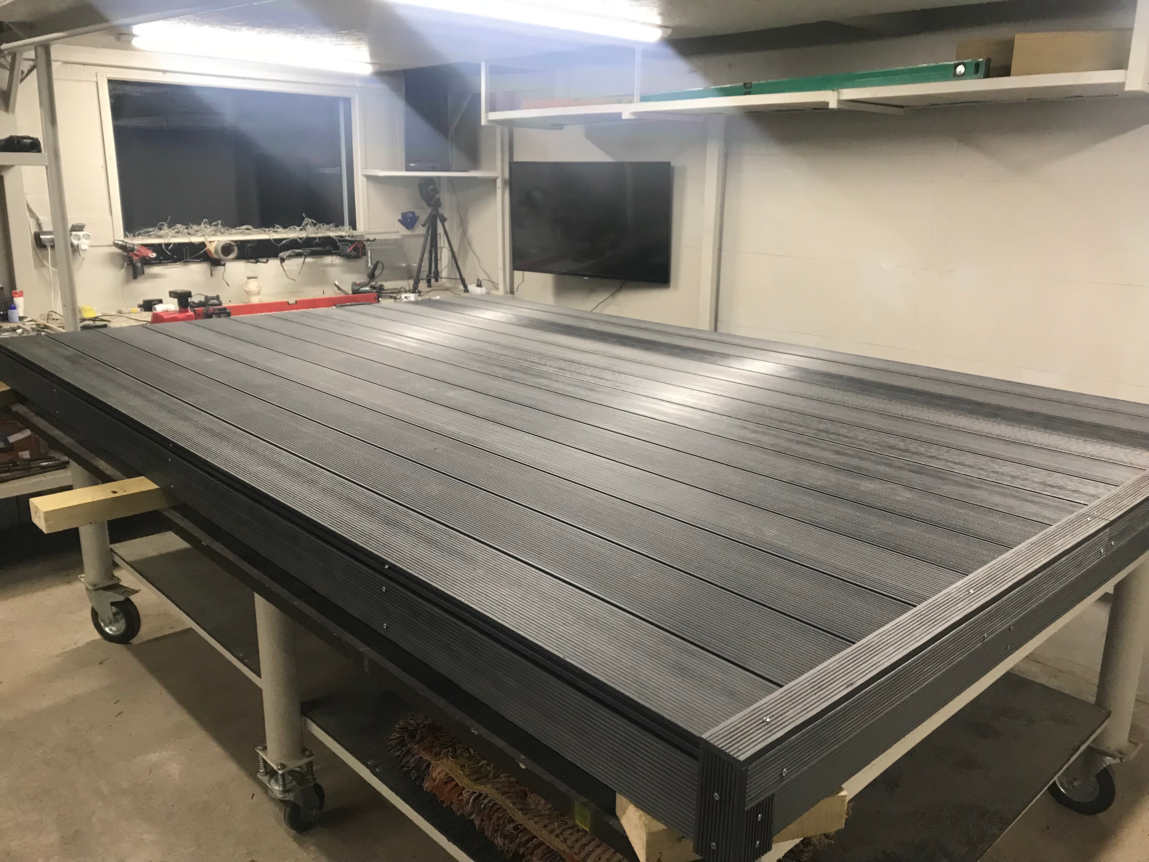 Large industrial workbench in a workshop setting with tools and equipment in the background.