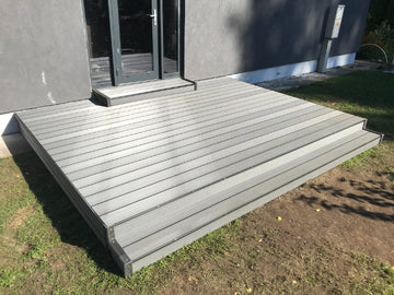 Gray composite deck leading to a house entrance