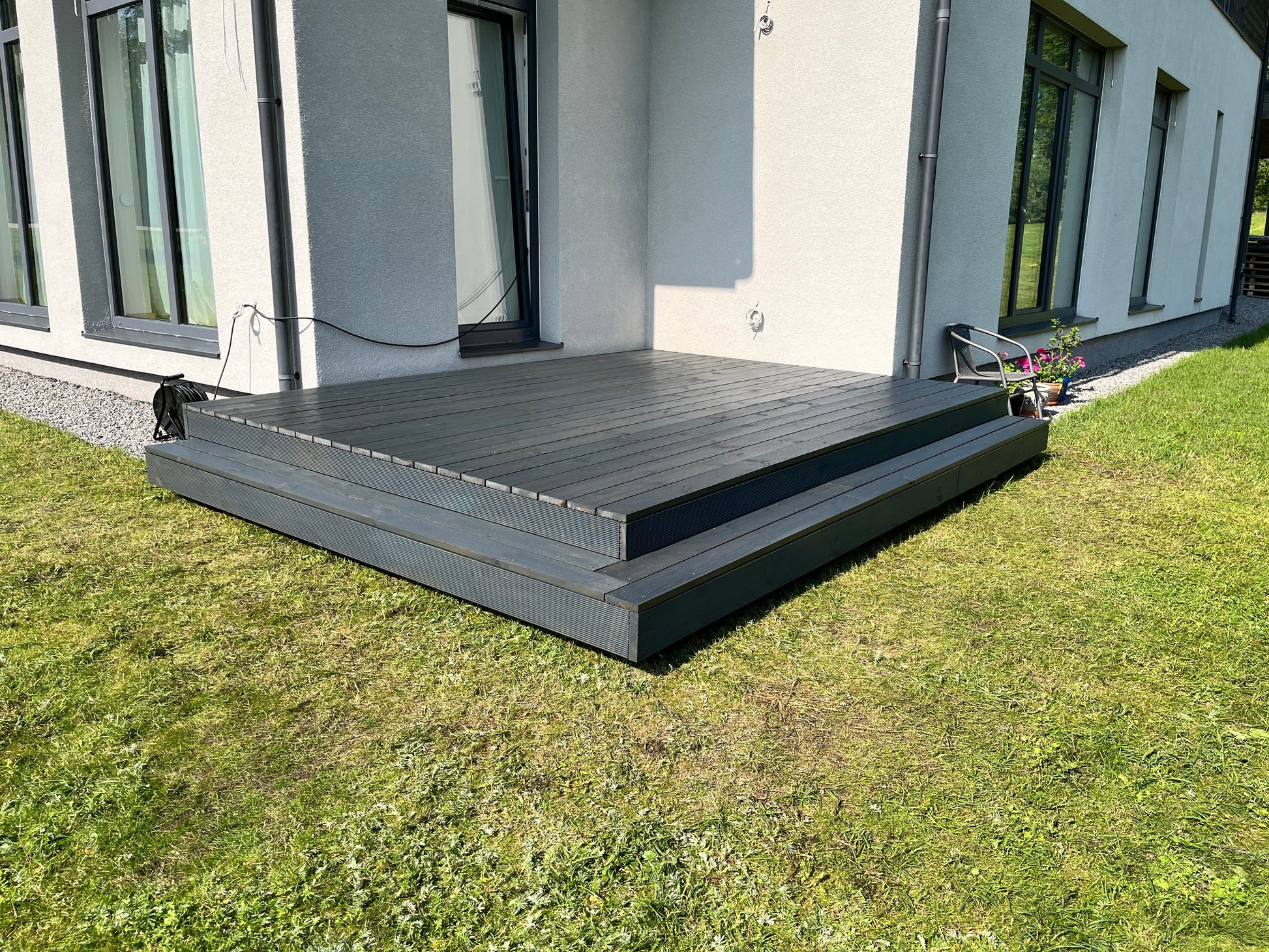 Modern house exterior with a newly constructed wooden deck.