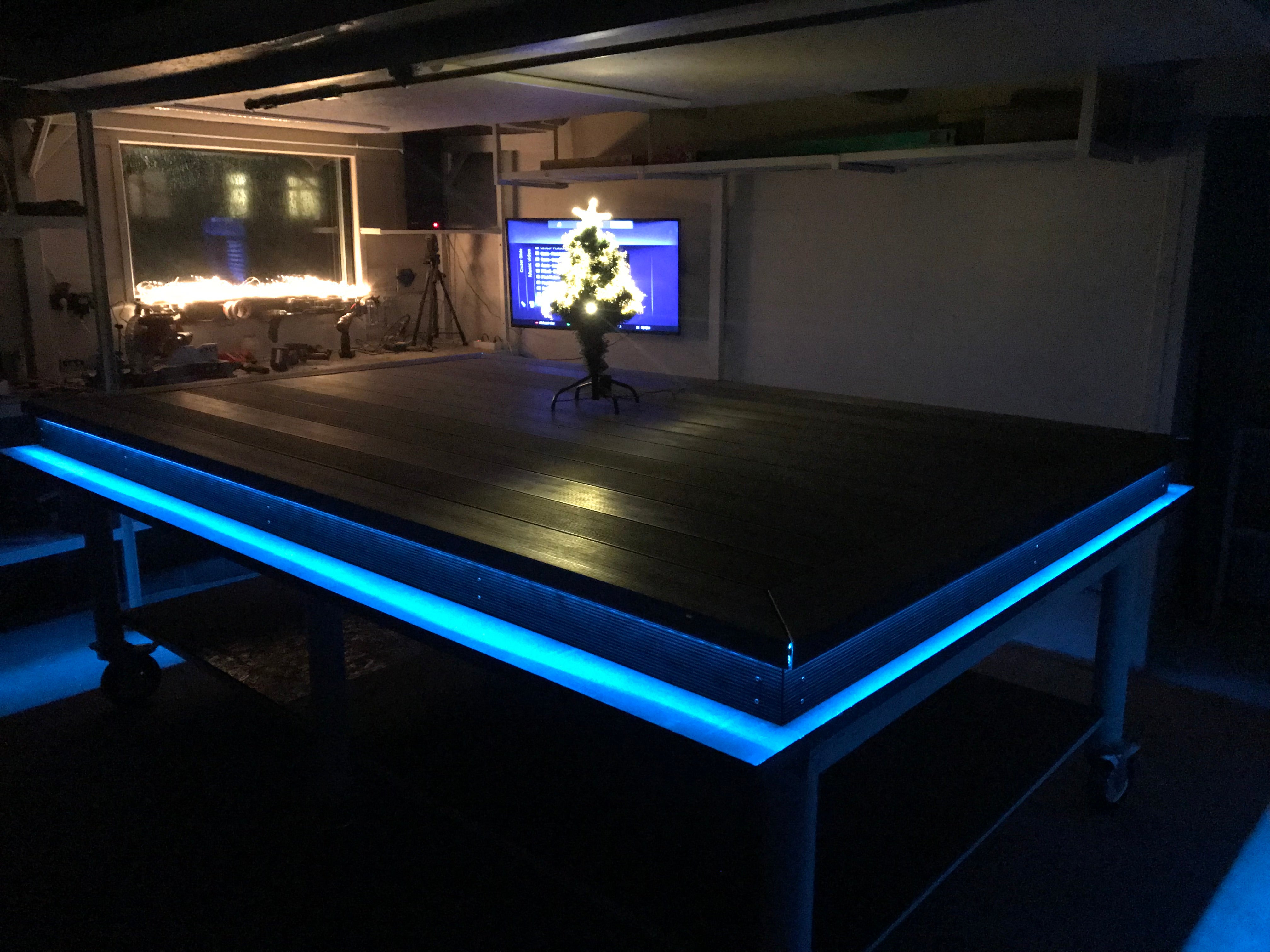 Large flat surface with blue LED lighting in a dark room