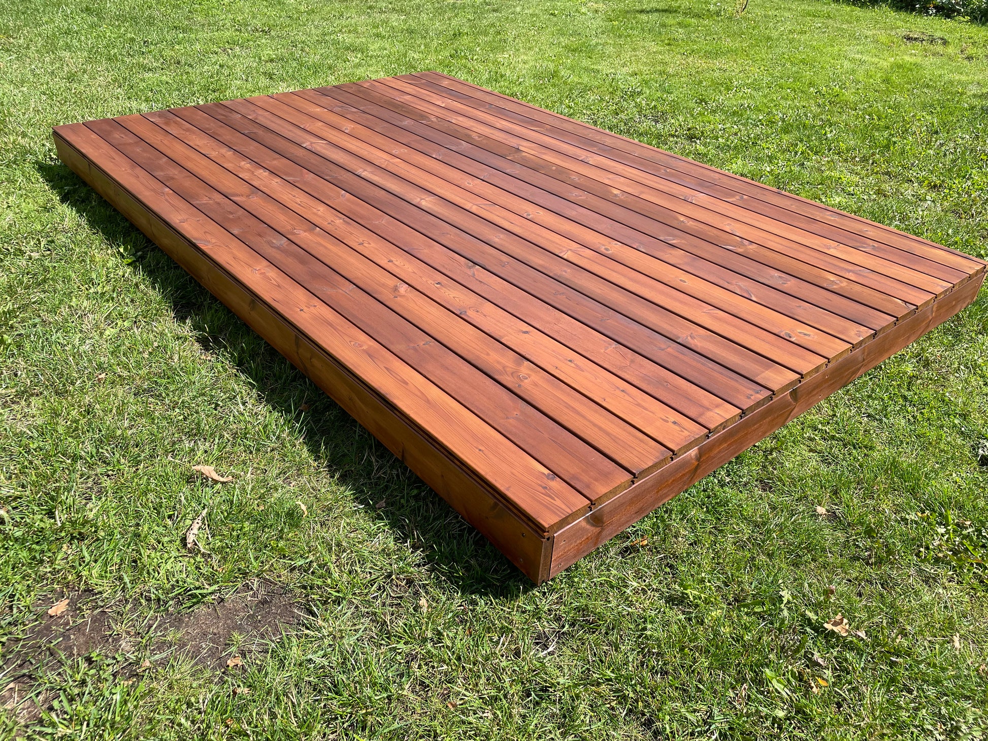 Wooden deck platform on grass