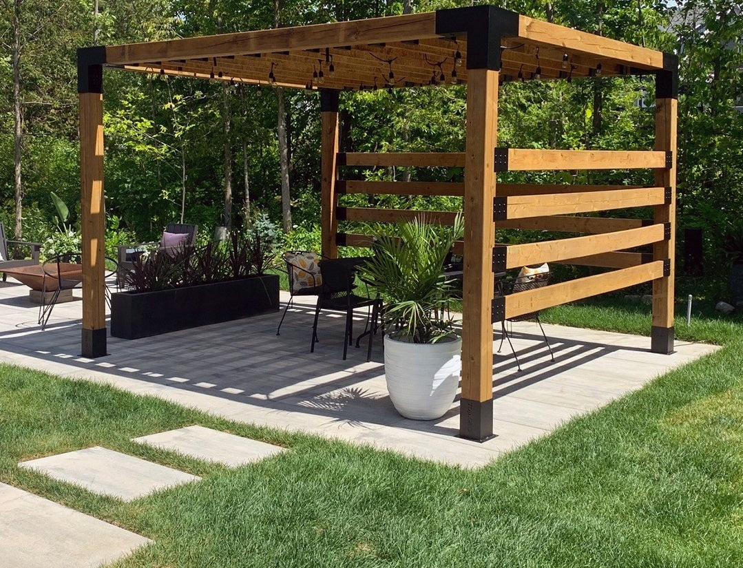 Wooden pergola with outdoor furniture and plants on a patio