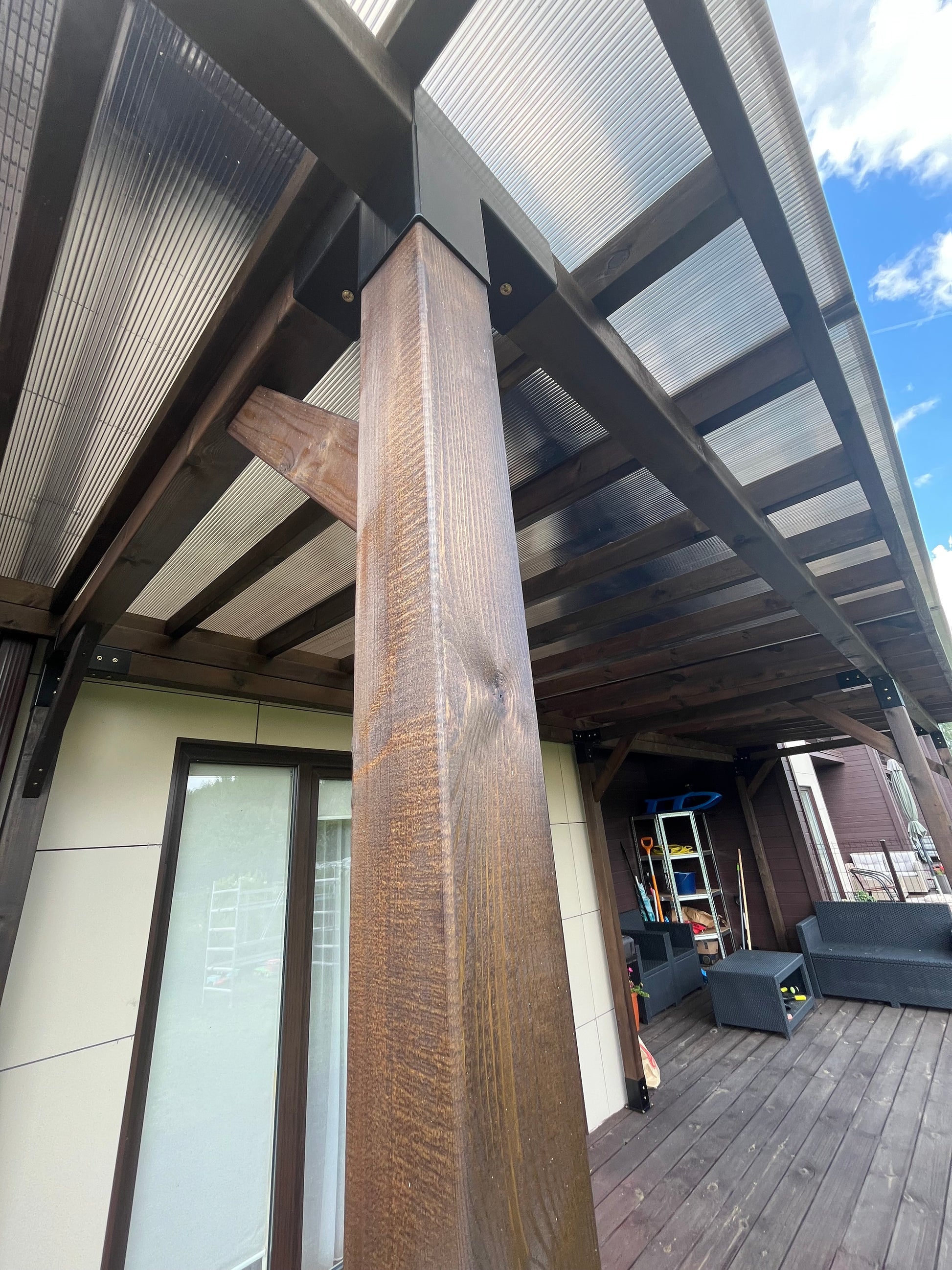 Wooden staircase leading to an outdoor area with a clear sky.
