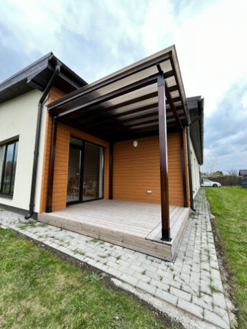Modern house exterior with a covered porch and grassy area