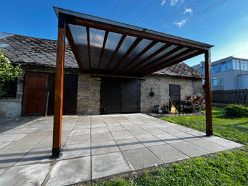 Wooden pergola over a patio area with a clear blue sky