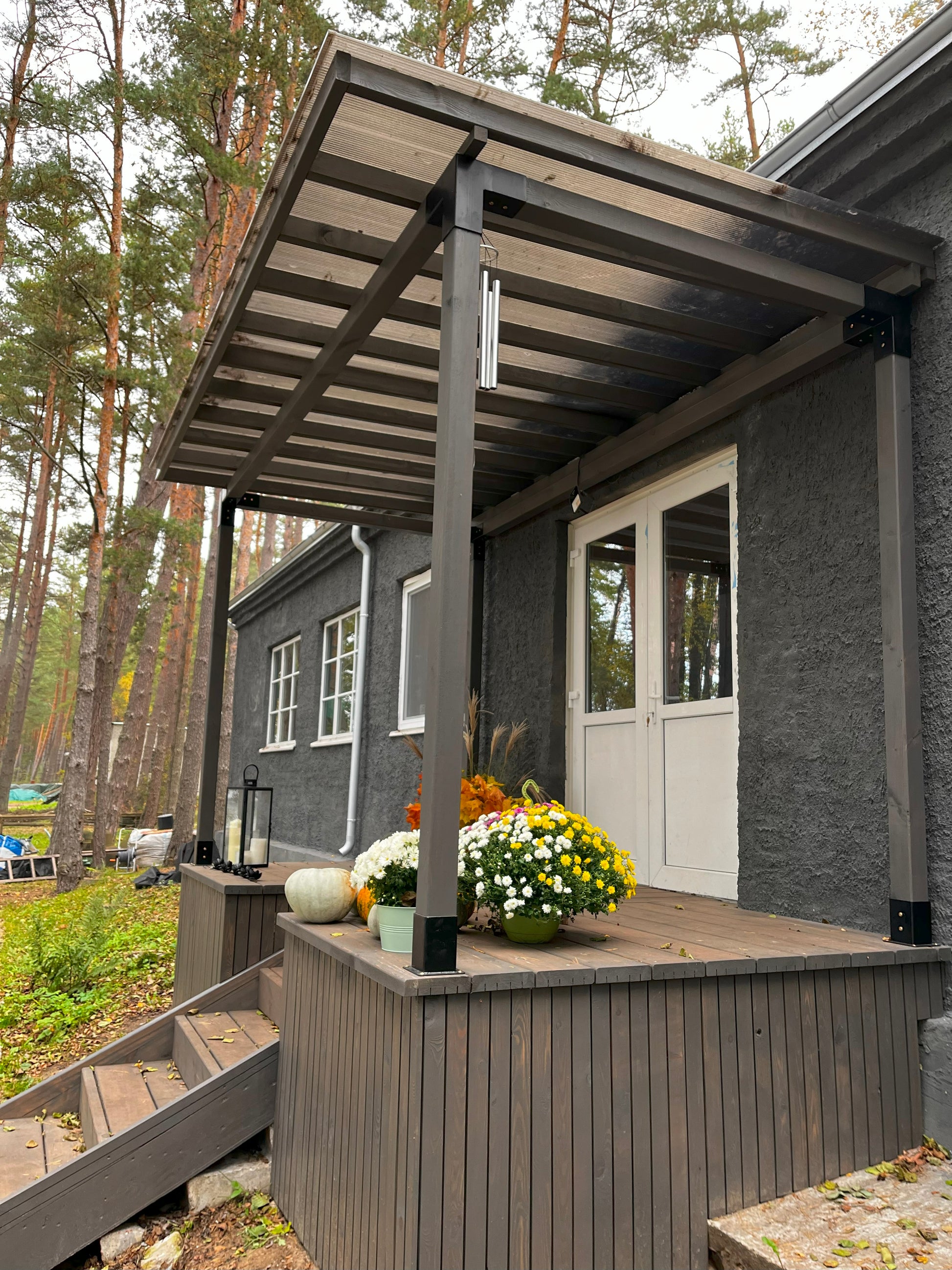 Porch with wooden pergola and flowers 