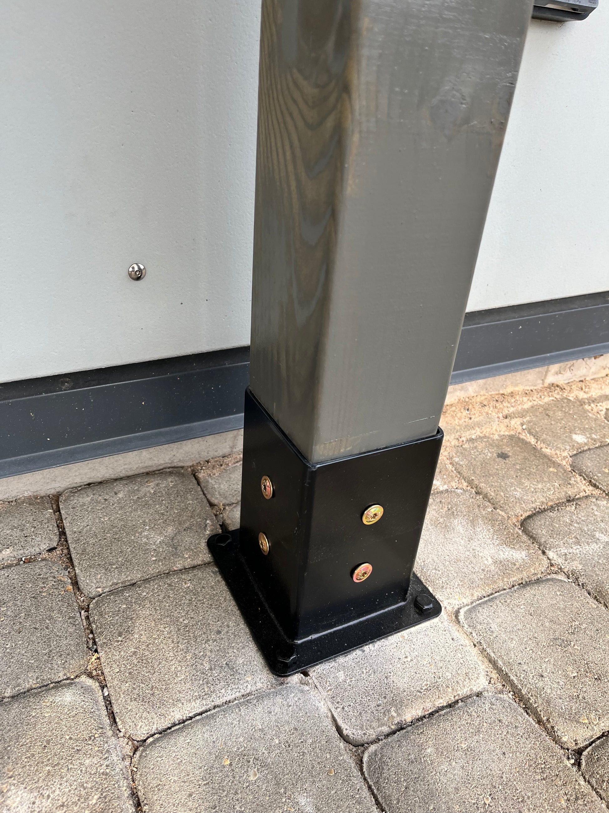 Metal bracket on a paved surface