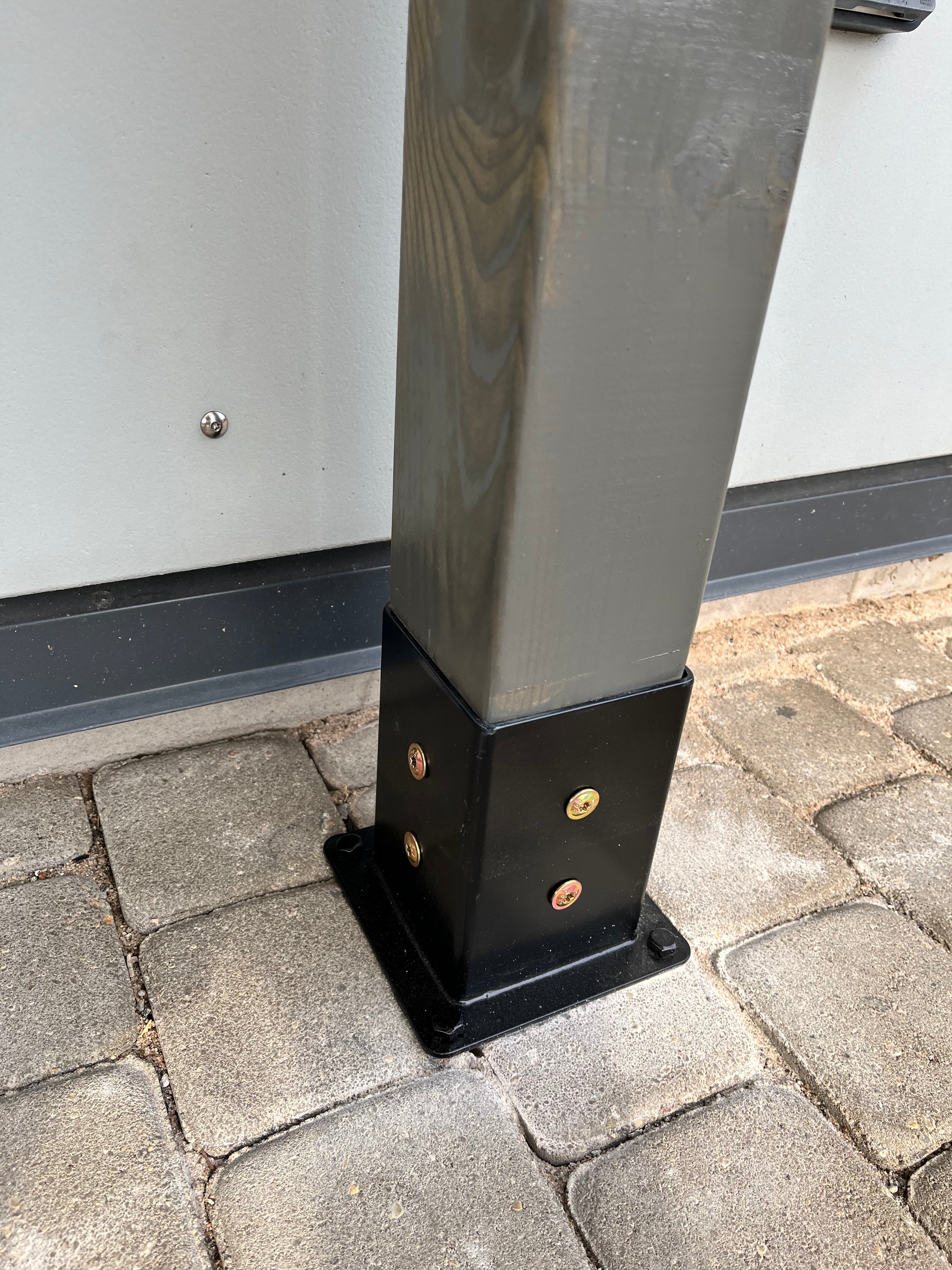 Metal bracket on a paved surface