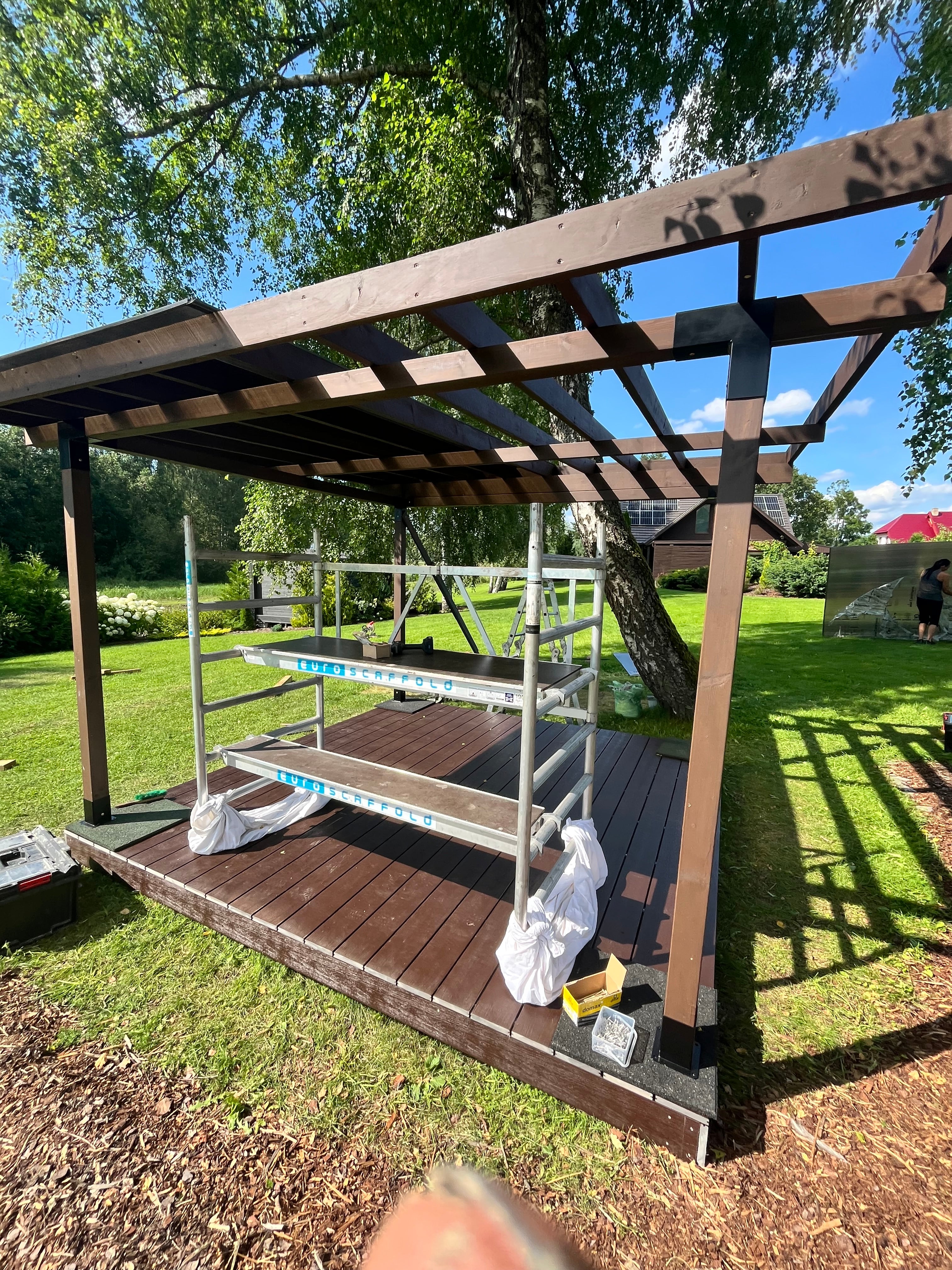 Wooden structure with a glass panel on a grassy area