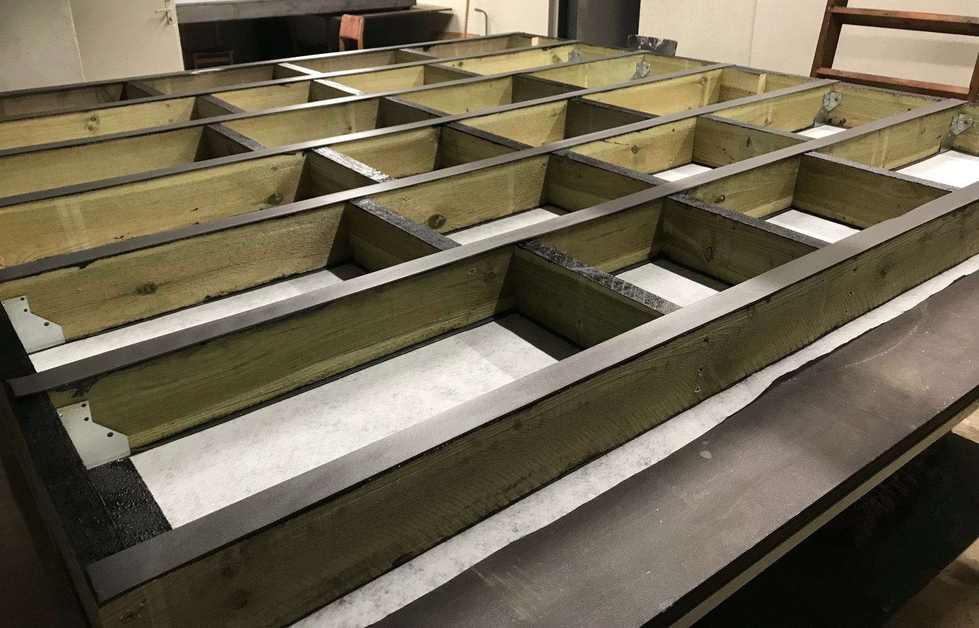 Wooden beams with metal brackets on table