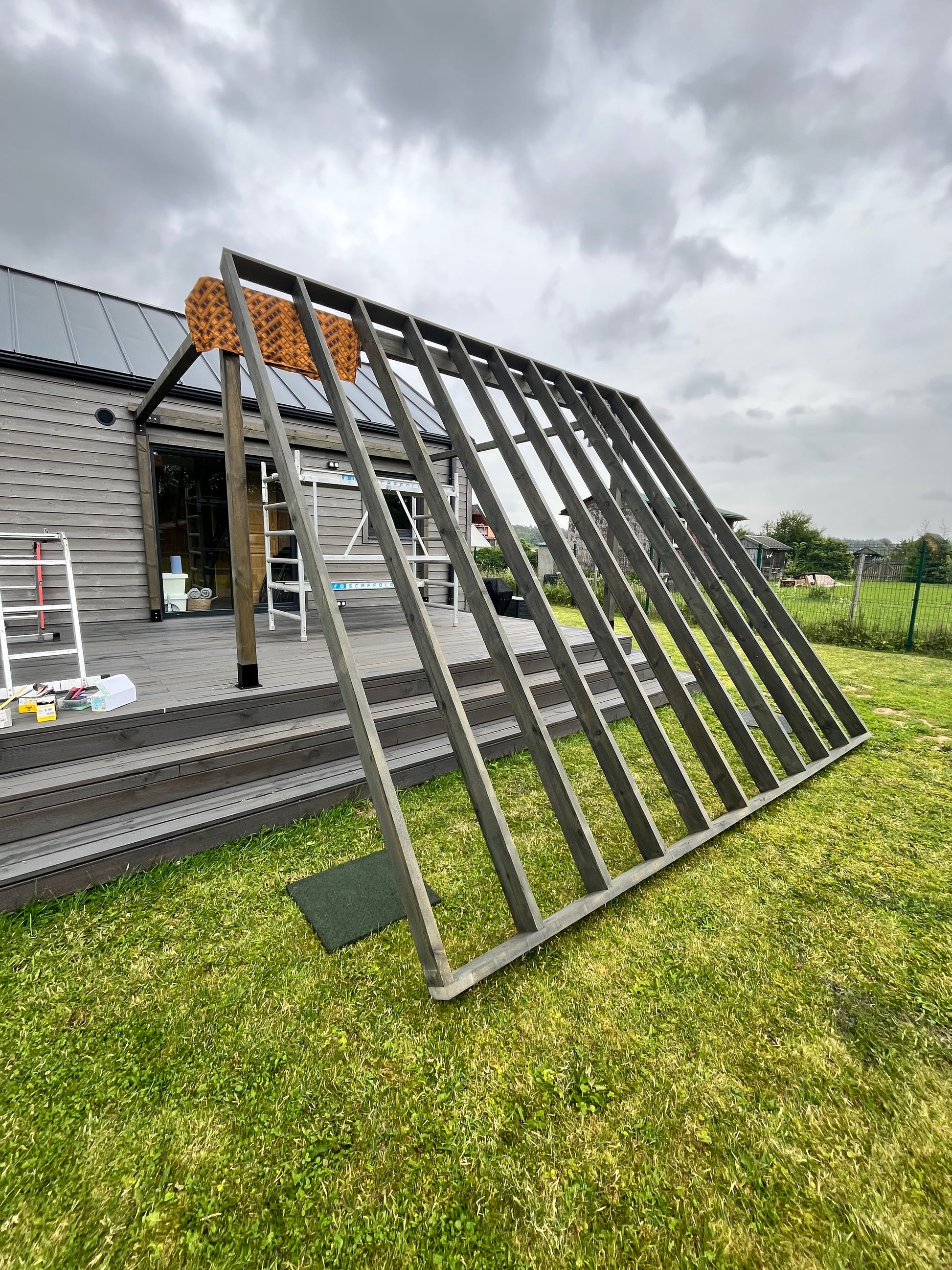 Metal roof rack on a vehicle with grass and cloudy sky in the background