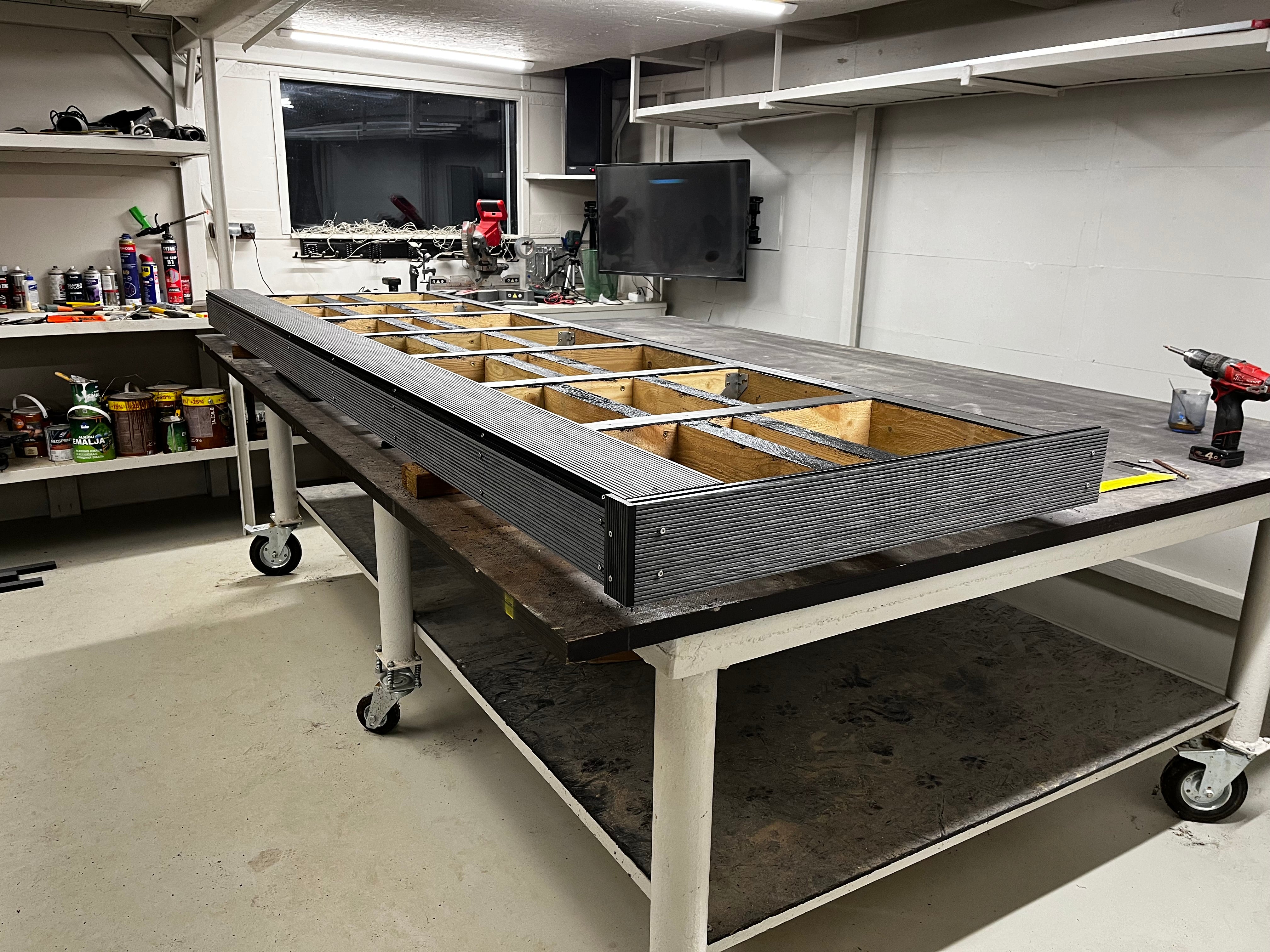 Workshop setting with a composite deck and tools.