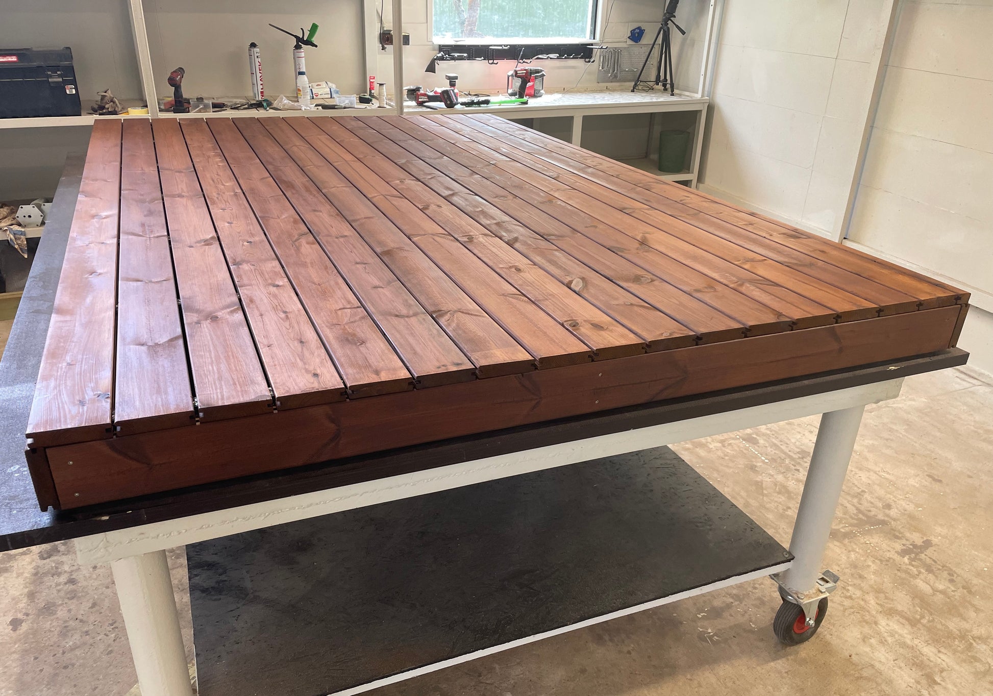 Wooden workbench with a metal base in a workshop setting