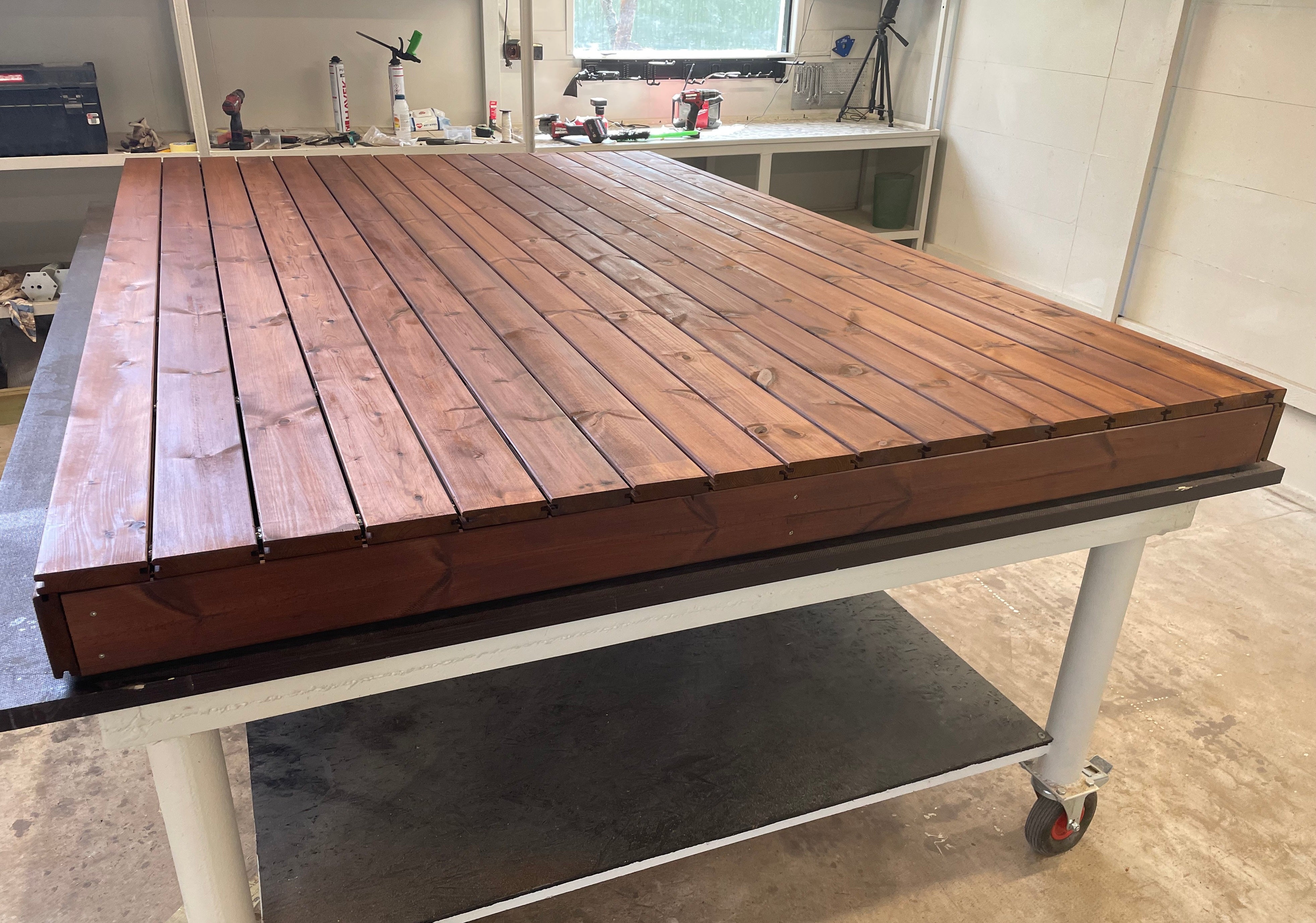 Wooden workbench with a metal base in a workshop setting