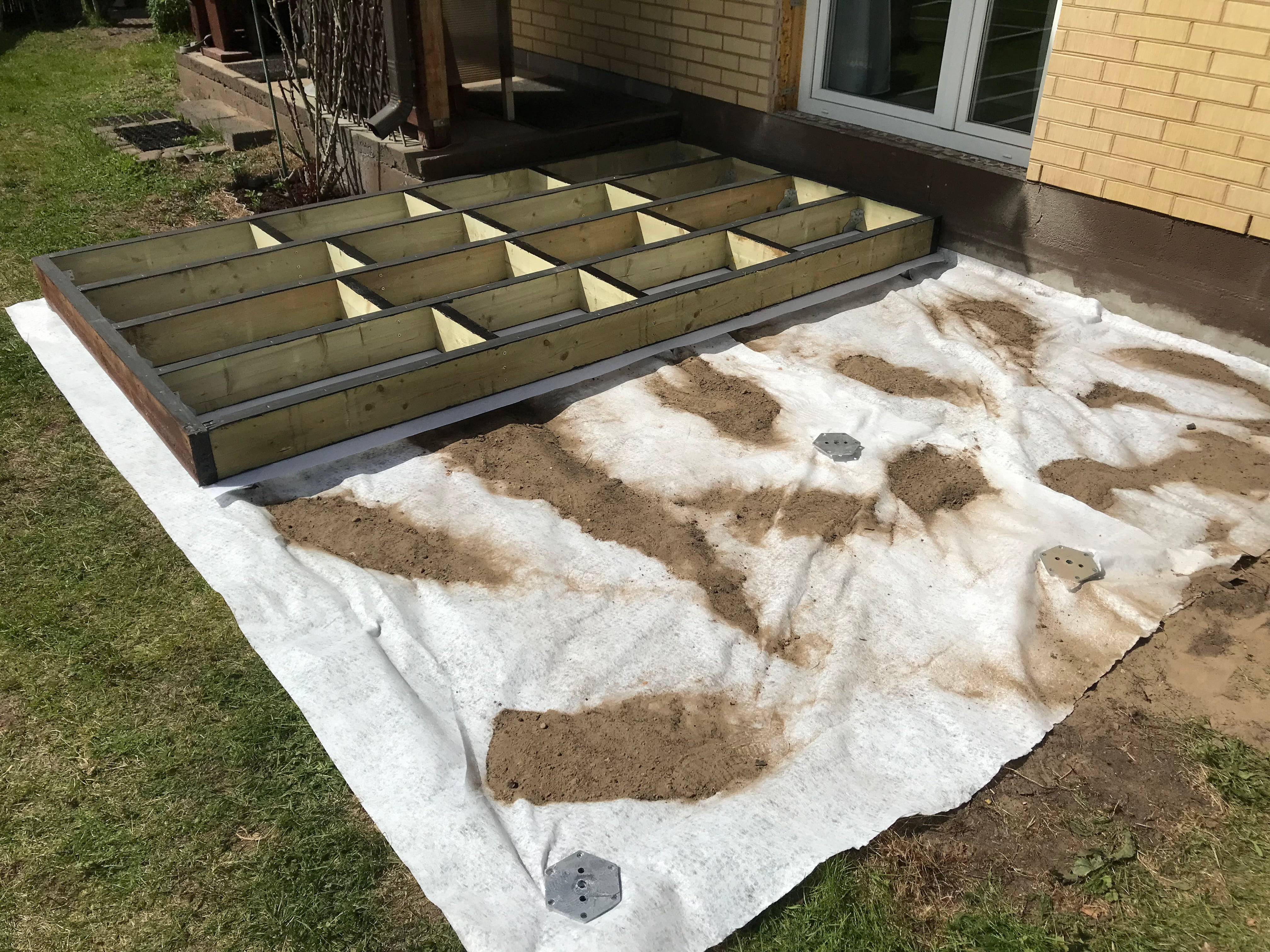 Foundation form for a concrete patio or driveway in front of a house.